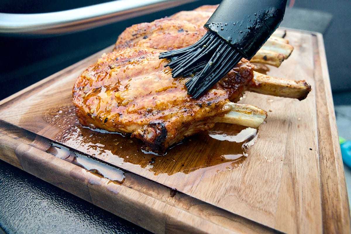Grilled Pork Chops Being Glazed