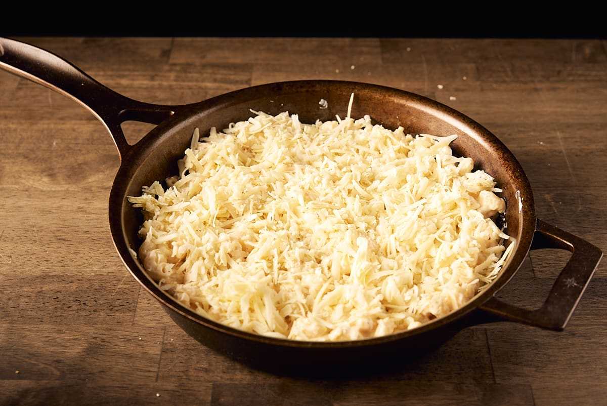 Add 2 cups of shredded cheese on top of the pasta mixture